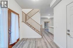 Entrance foyer featuring light wood-style floors and stairway -