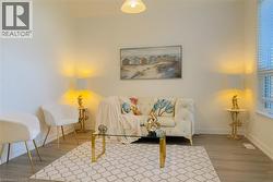 Sitting room with baseboards and wood finished floors -