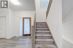 Staircase with wood finished floors and baseboards -