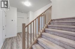 Stairs featuring wood finished floors and baseboards -