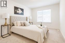 Bedroom featuring light carpet and baseboards -