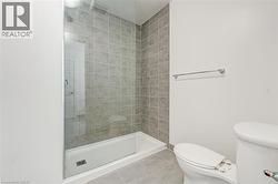 Bathroom with tile patterned floors and a stall shower -