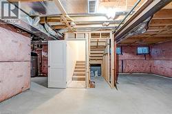 Basement featuring stairs and water heater -