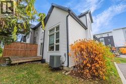 View of property exterior featuring a wooden deck and a yard -