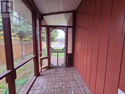 The quaint screened in side porch. -