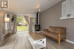 The sunroom features a gas fireplace. -