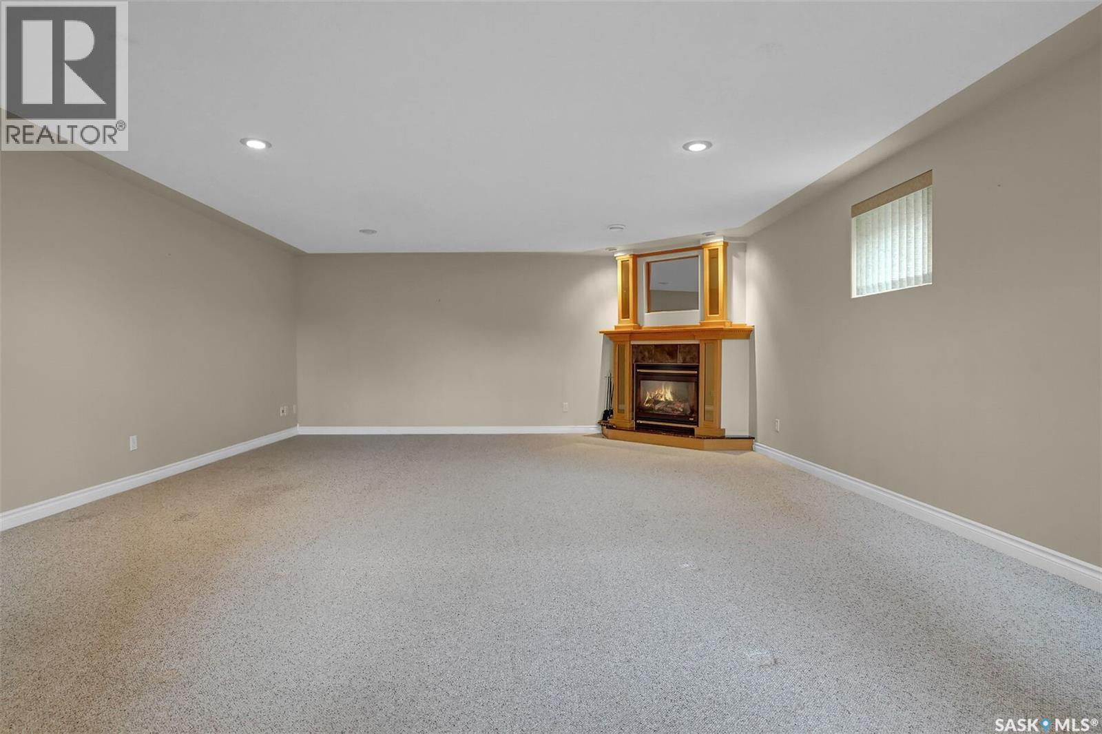 21 Woods Crescent, Edenwold Rm No.158, SK - Indoor Photo Showing Other Room With Fireplace