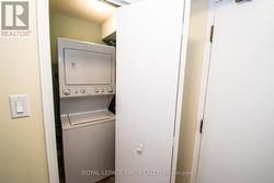 In-suite laundry with storage tucked to one side -
