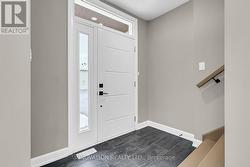 Foyer with ceramic tile. -