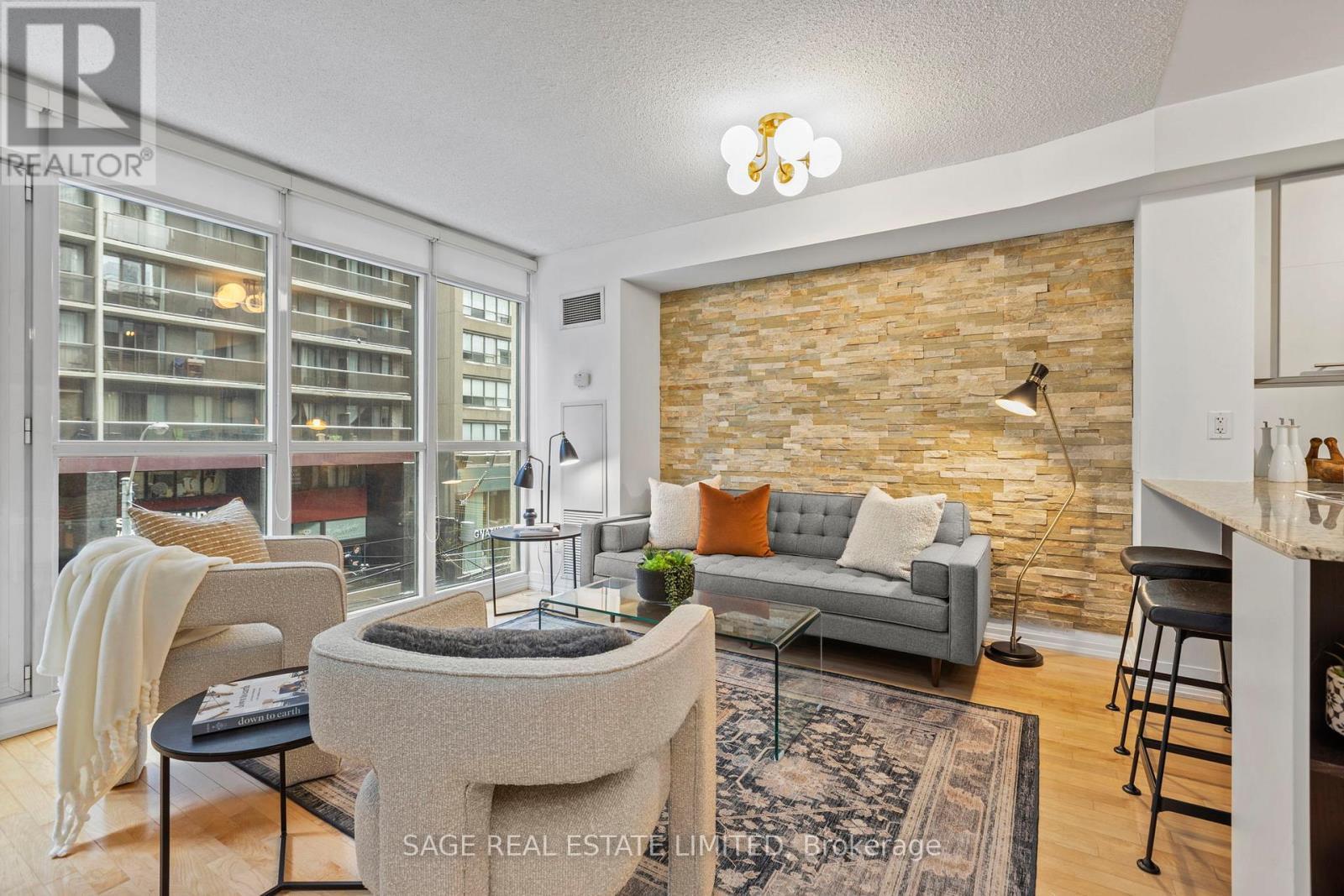 Huge Living Room with gorgeous stone accent wall! - 328 - 25 Carlton Street, Toronto, ON - Indoor Photo Showing Living Room