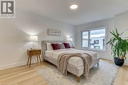 Bedroom with baseboards and light wood-type flooring -