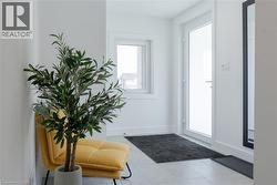 Doorway featuring tile patterned floors and baseboards -