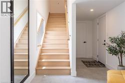 Staircase featuring baseboards and recessed lighting -