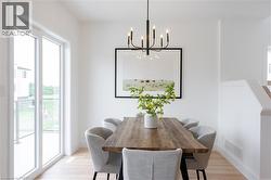 Dining space featuring light wood finished floors and a chandelier -