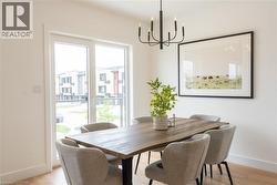 Dining space featuring a chandelier and light wood finished floors -