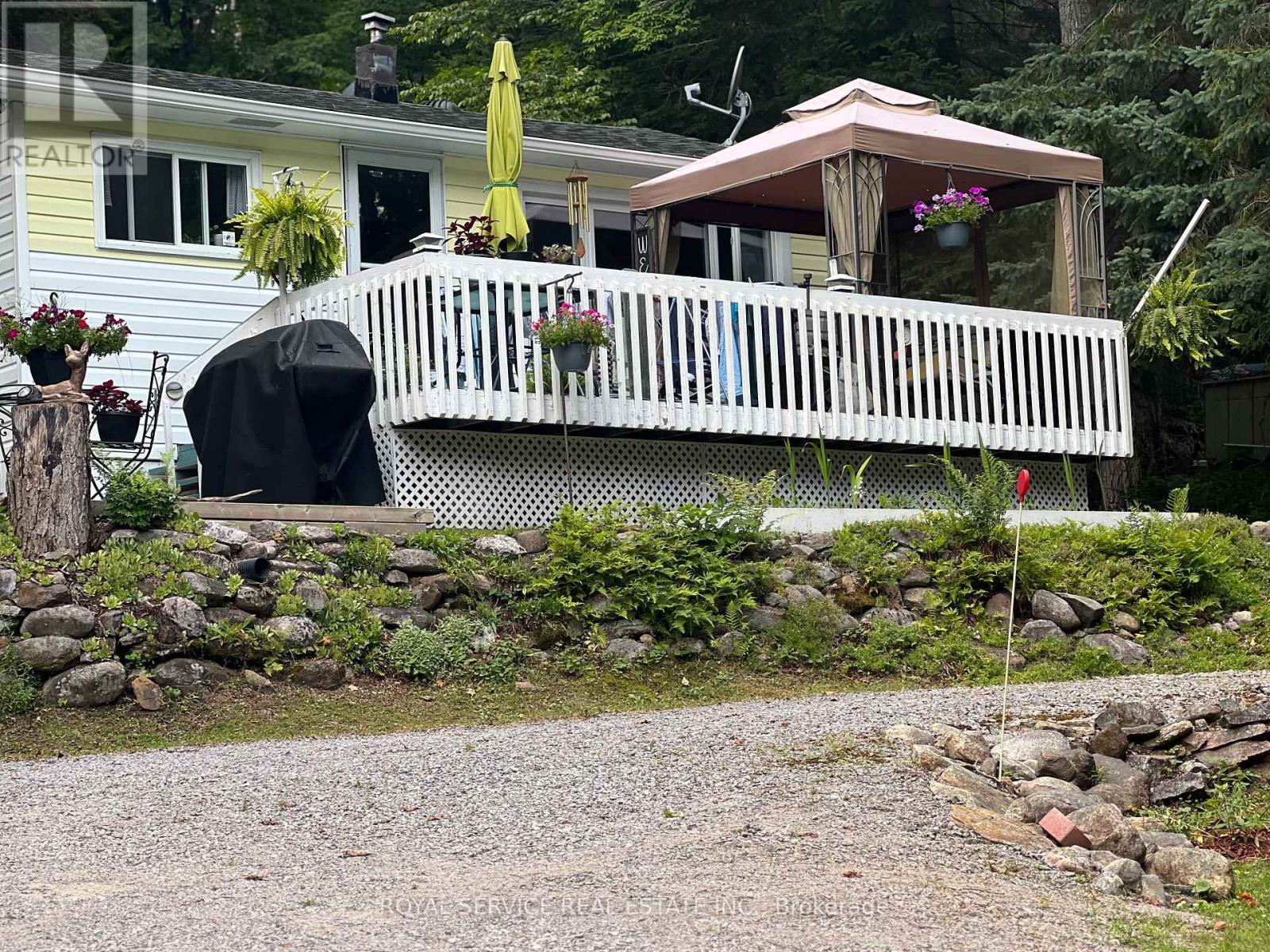 Sellers Summer Photo - 1039 Grace River Road, Highlands East (Monmouth), ON - Outdoor With Deck Patio Veranda