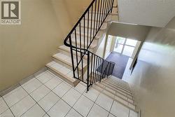Staircase featuring tile patterned flooring and a textured ceiling -