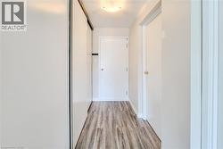 Unit entrance hall featuring a textured ceiling and light wood-style flooring -