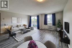 Staged: Large open living area with a wall unit AC -