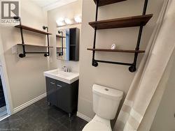 4 piece bathroom with vanity, bathtub, shower combination and wall shelves -