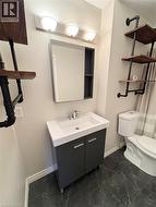 4 piece bathroom with vanity, bathtub, shower combination and wall shelves -