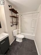 4 piece bathroom with vanity, bathtub, shower combination and wall shelves -