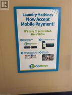 Building phone app laundry located on the main floor. Workout area featuring stacked washer and dryer. -