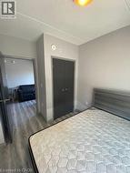 Bedroom featuring wood finished floors, a closet, and a textured ceiling -