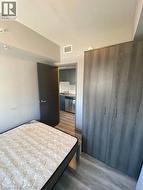 Bedroom featuring wood finished floors, a closet, and a textured ceiling -