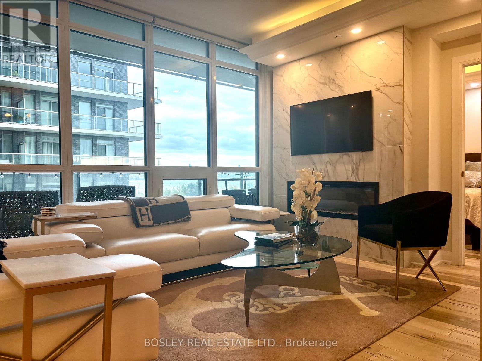 302 - 59 Annie Craig Drive, Toronto, ON - Indoor Photo Showing Living Room With Fireplace