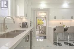 Additional cabinets behind the bar stools -