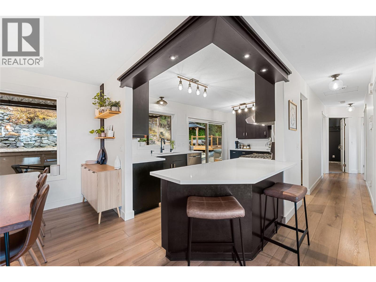 Attractive kitchen and dining areas with options for a family on the go. - 3380 Mciver Road, West Kelowna, BC - Indoor