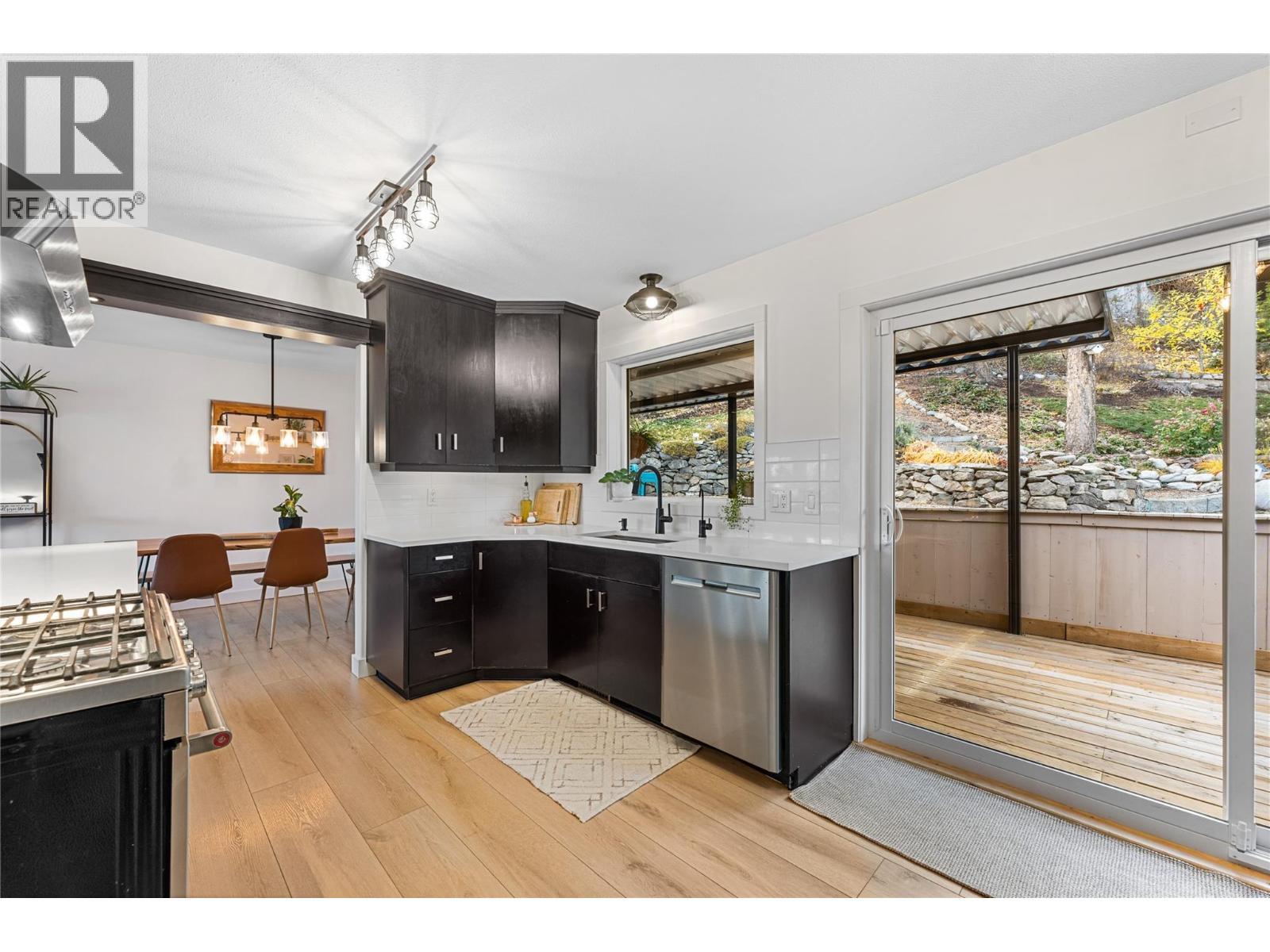 New windows and over-sized sliding door to your backyard retreat. - 3380 Mciver Road, West Kelowna, BC - Indoor Photo Showing Kitchen