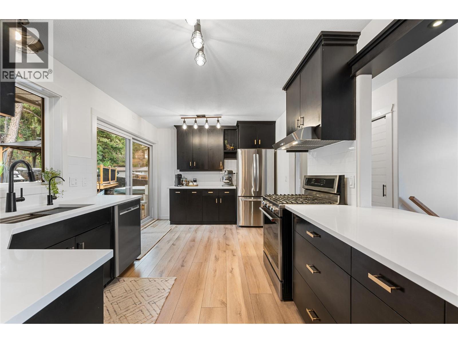 Updated kitchen - quartz countertops, cabinets, under-mount sink, lighting and appliances. - 3380 Mciver Road, West Kelowna, BC - Indoor Photo Showing Kitchen