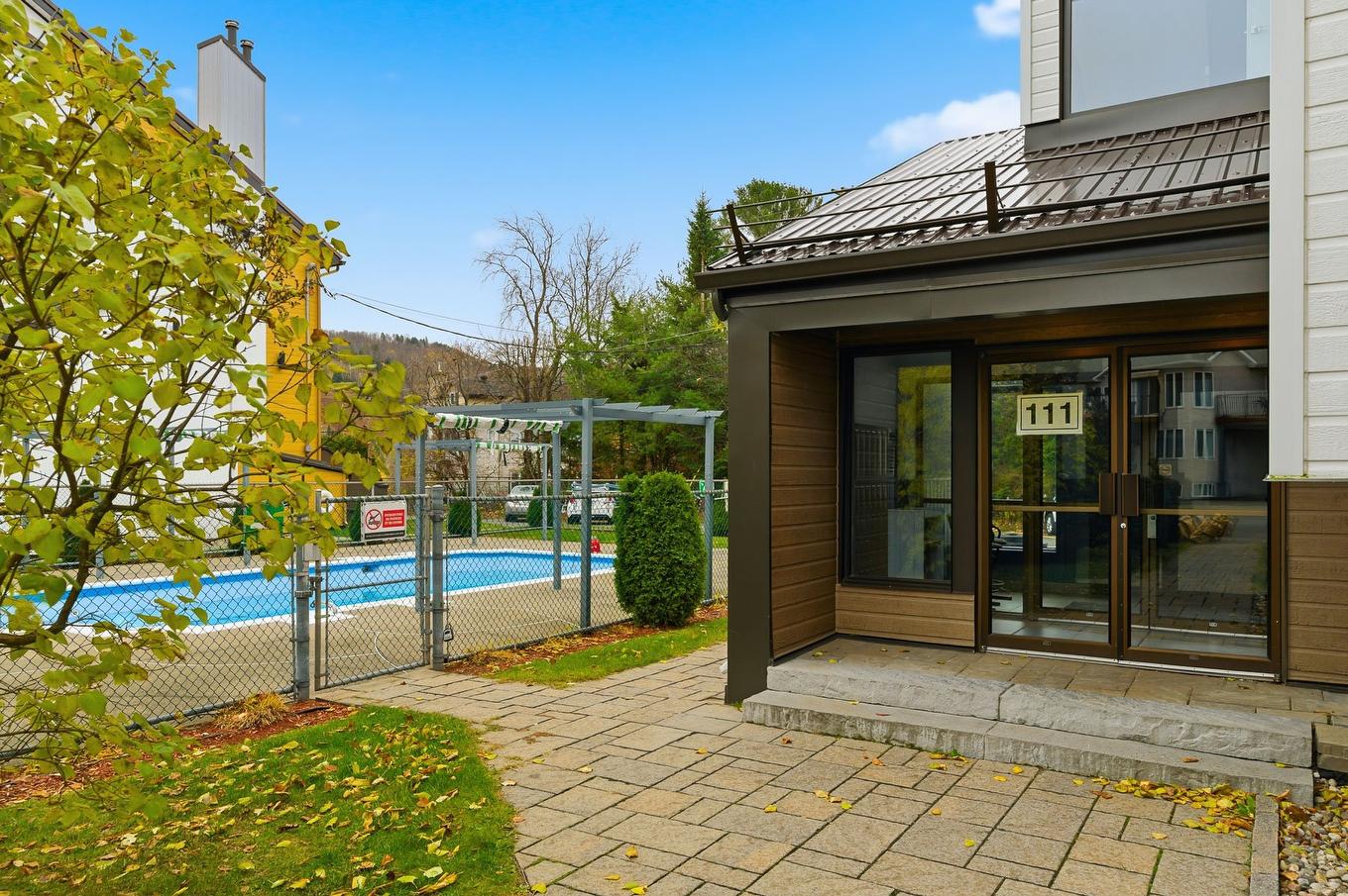 Exterior entrance - 201-111 Av. Hochar, Saint-Sauveur, QC - Outdoor With In Ground Pool