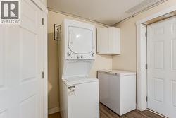 Lower level laundry with two sets of washers/dryers -