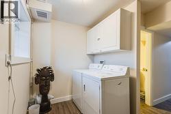 Lower level laundry with two sets of washers/dryers -