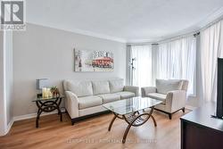 Bright living room with newer flooring. -