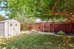 Impecably maintained yard with deck, patio & shed. -