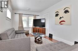 Living room with wood finished floors and baseboards -