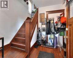 Staircase with wood finished floors and healthy amount of natural light -