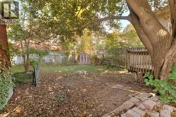 Fenced backyard with a storage shed and a wooden deck -