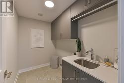 Second floor laundry room with built in cabinetry -