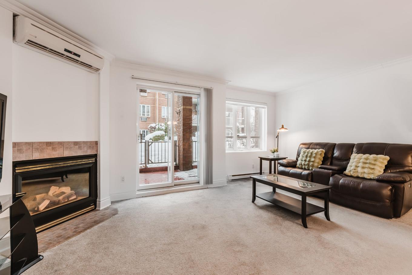 Living room - 101-2815 Boul. René-Laennec, Laval (Vimont), QC - Indoor Photo Showing Living Room With Fireplace