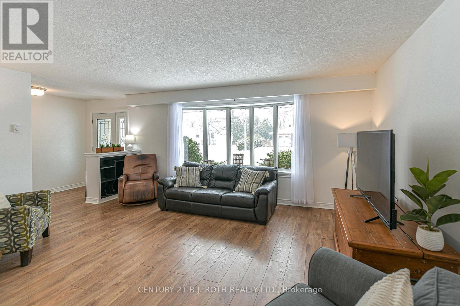 Open living room with bay window - 201 Point Street, Clearview, ON - Indoor Photo Showing Living Room