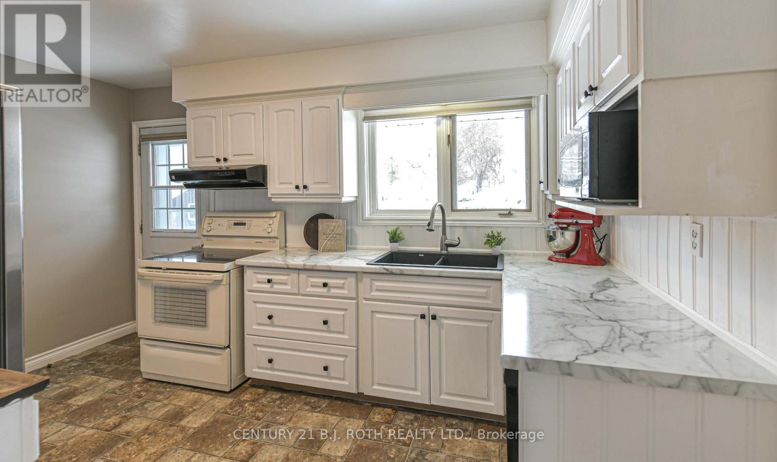 Kitchen with views of pool and backyard - 201 Point Street, Clearview, ON - Indoor Photo Showing Kitchen