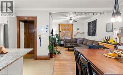 Dining area with crown molding, light wood finished floors, and ceiling fan -