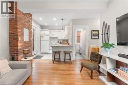 Living area featuring light wood-style flooring, recessed lighting, and electric panel -
