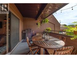 Spacious Main Patio surrounded by greenery, with a Gas BBQ Hookup. -
