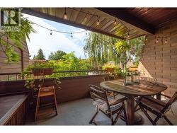 Spacious Main Patio surrounded by greenery, with a Gas BBQ Hookup. -